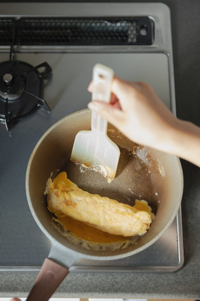 Homemade sweet and savory Japanese tamagoyaki rolled omelet sliced on a plate