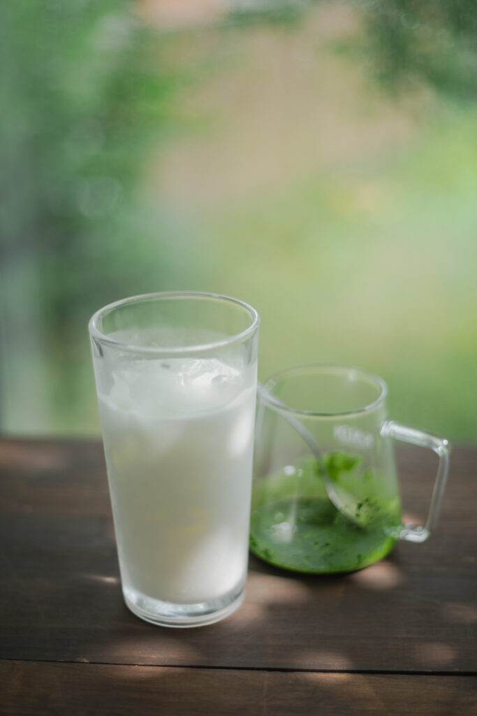 Homemade authentic Japanese iced matcha latte with a beautiful green and white marble layer in a tall glass
