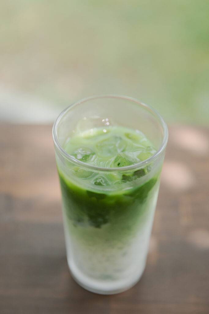 Homemade authentic Japanese iced matcha latte with a beautiful green and white marble layer in a tall glass