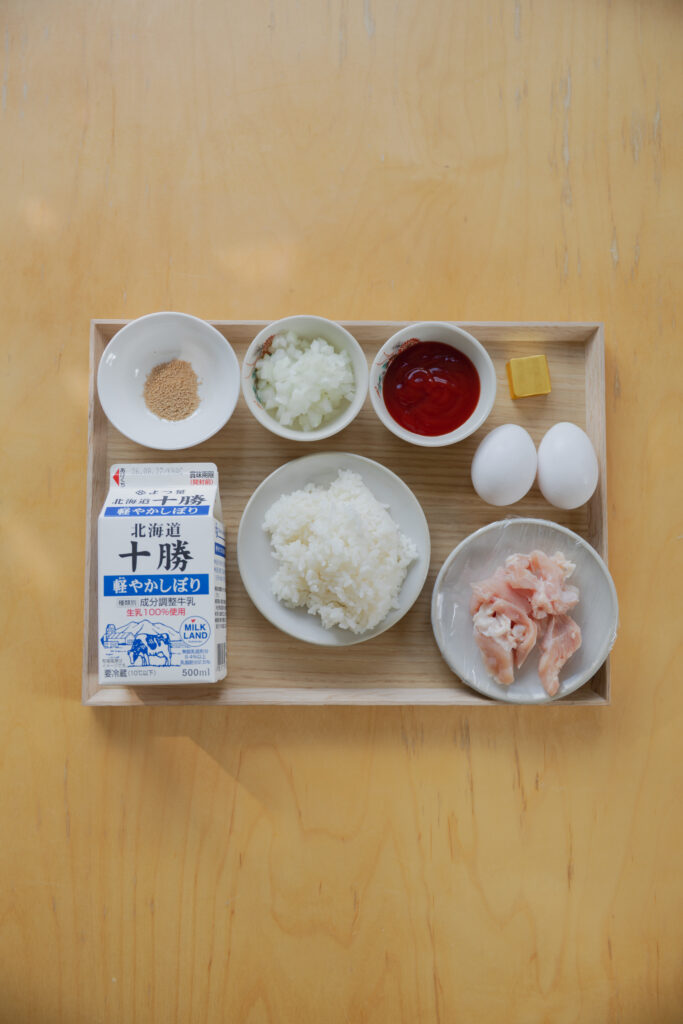 Homemade Japanese omurice chicken rice bowl topped with a fluffy runny omelet and ketchup