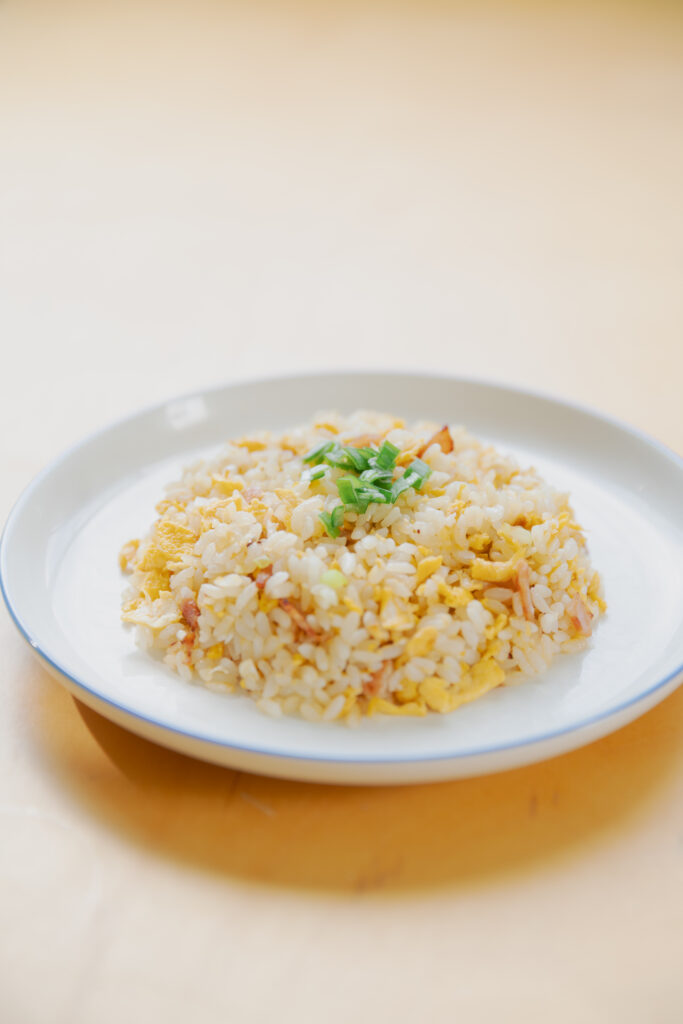 Homemade Japanese fried rice chahan with egg and bacon in a bowl