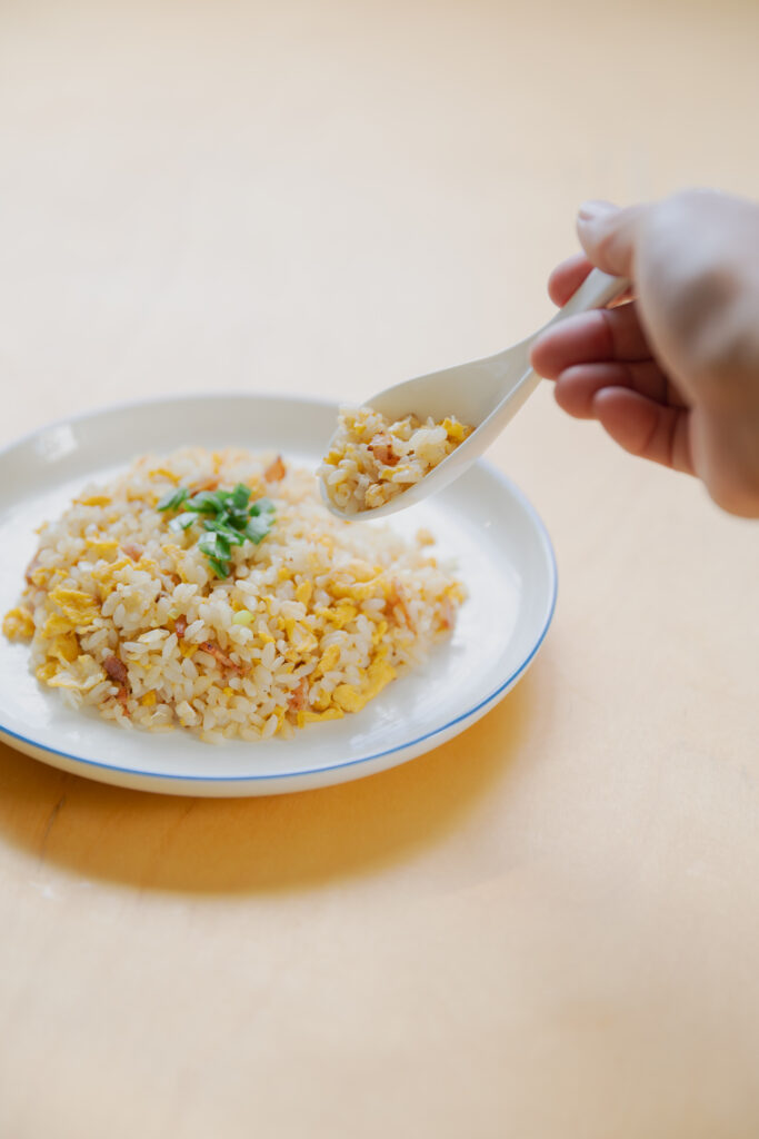 Homemade Japanese fried rice chahan with egg and bacon in a bowl