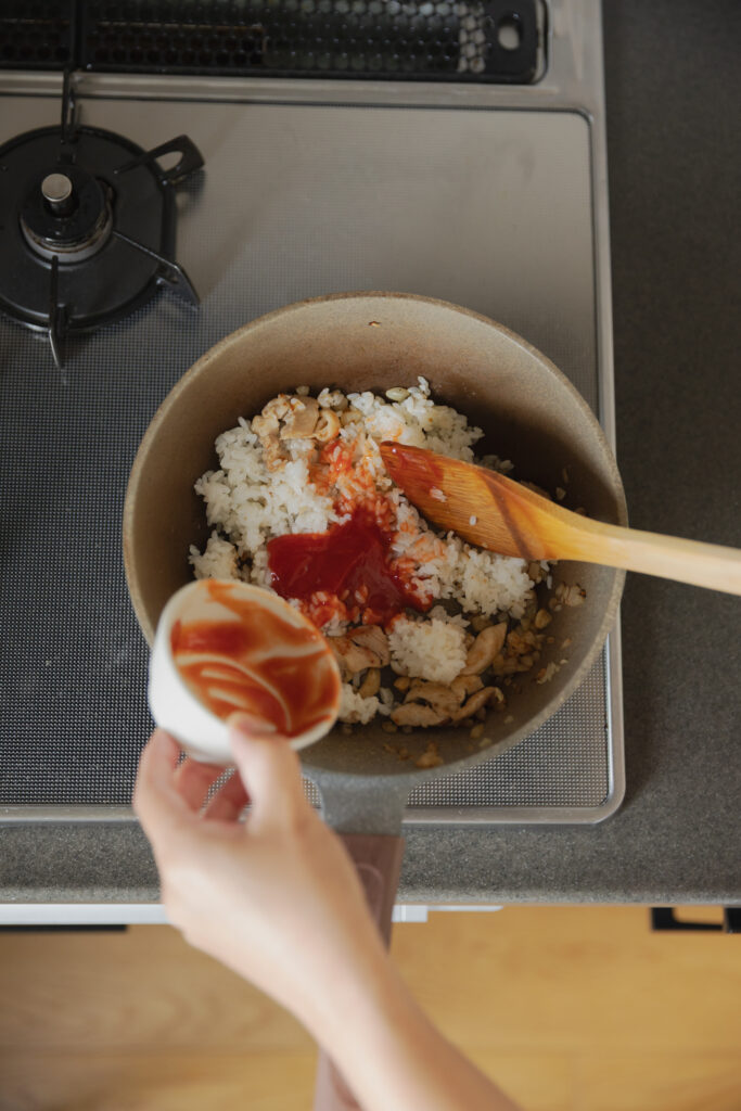 Homemade Japanese omurice chicken rice bowl topped with a fluffy runny omelet and ketchup