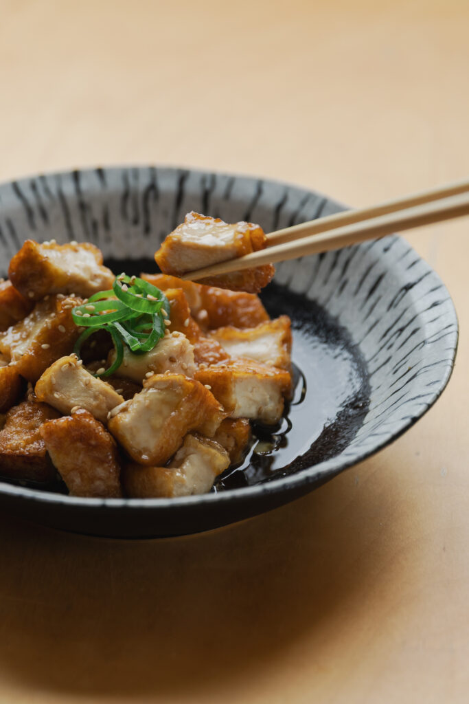 Homemade crispy Atsuage teriyaki deep-fried tofu cubes coated in a glossy sweet savory sauce