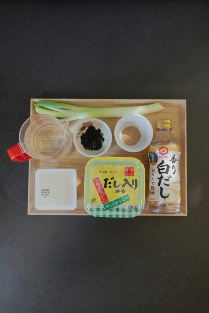 Homemade Japanese miso soup with tofu and green onions in a wooden bowl