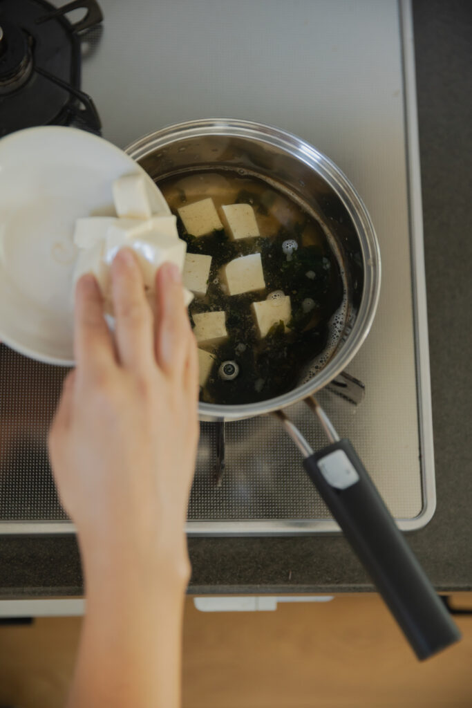 Homemade Japanese miso soup with tofu and green onions in a wooden bowl