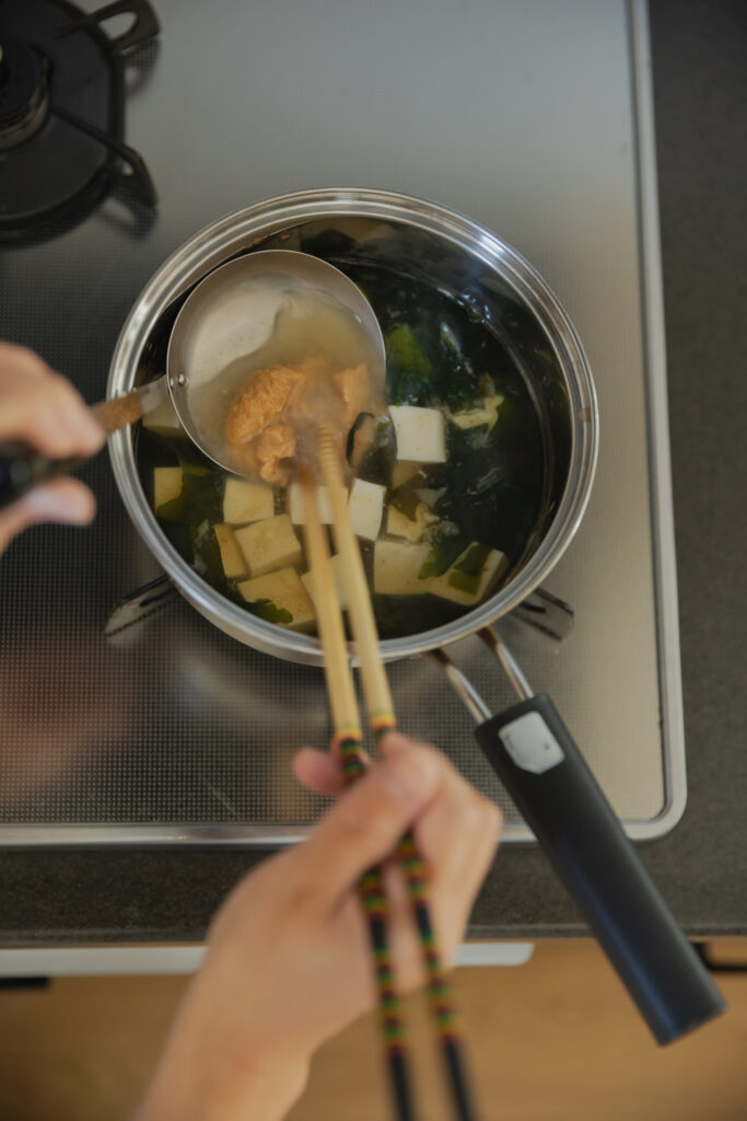 Homemade Japanese miso soup with tofu and green onions in a wooden bowl