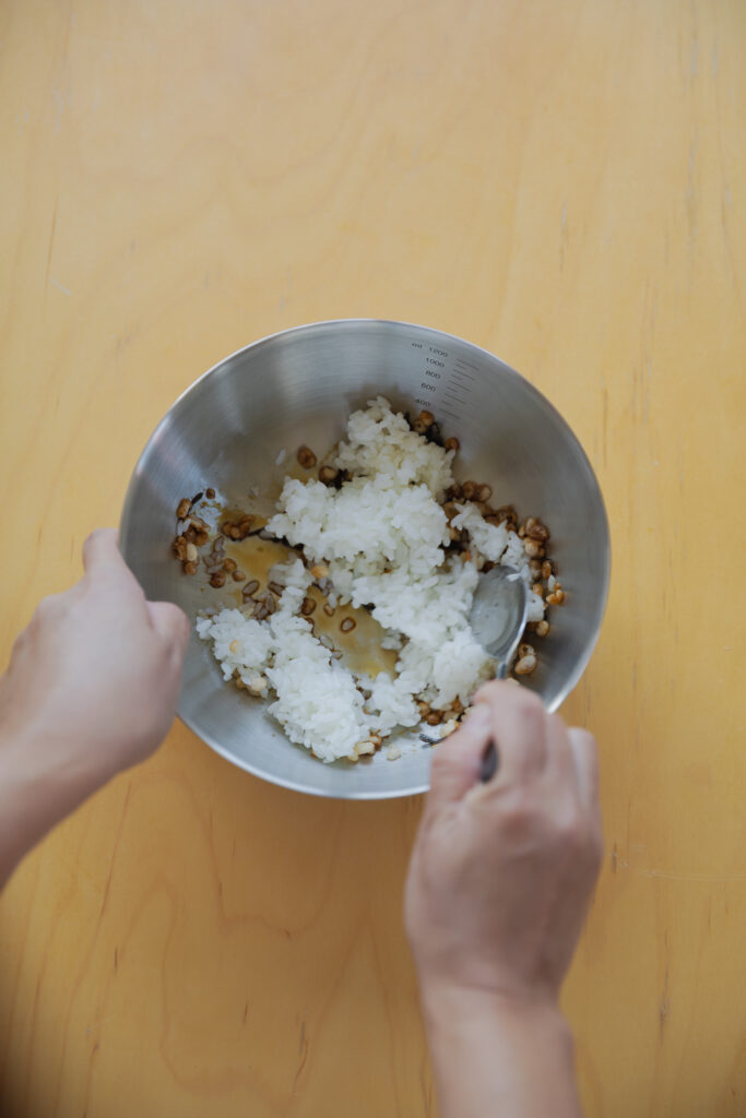 Four types of Japanese onigiri rice balls including salmon and tuna mayo on a bamboo basket