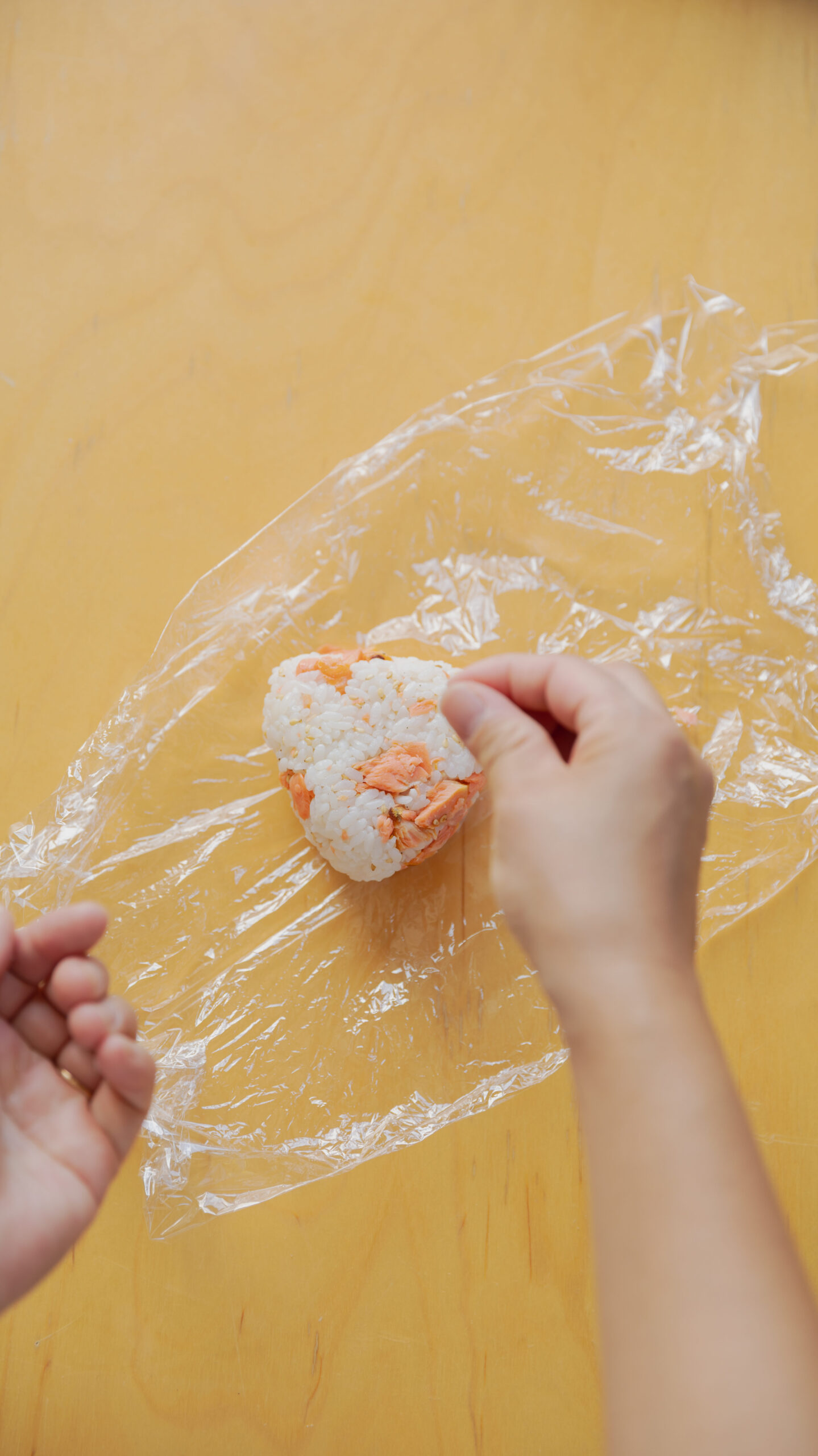 Four types of Japanese onigiri rice balls including salmon and tuna mayo on a bamboo basket