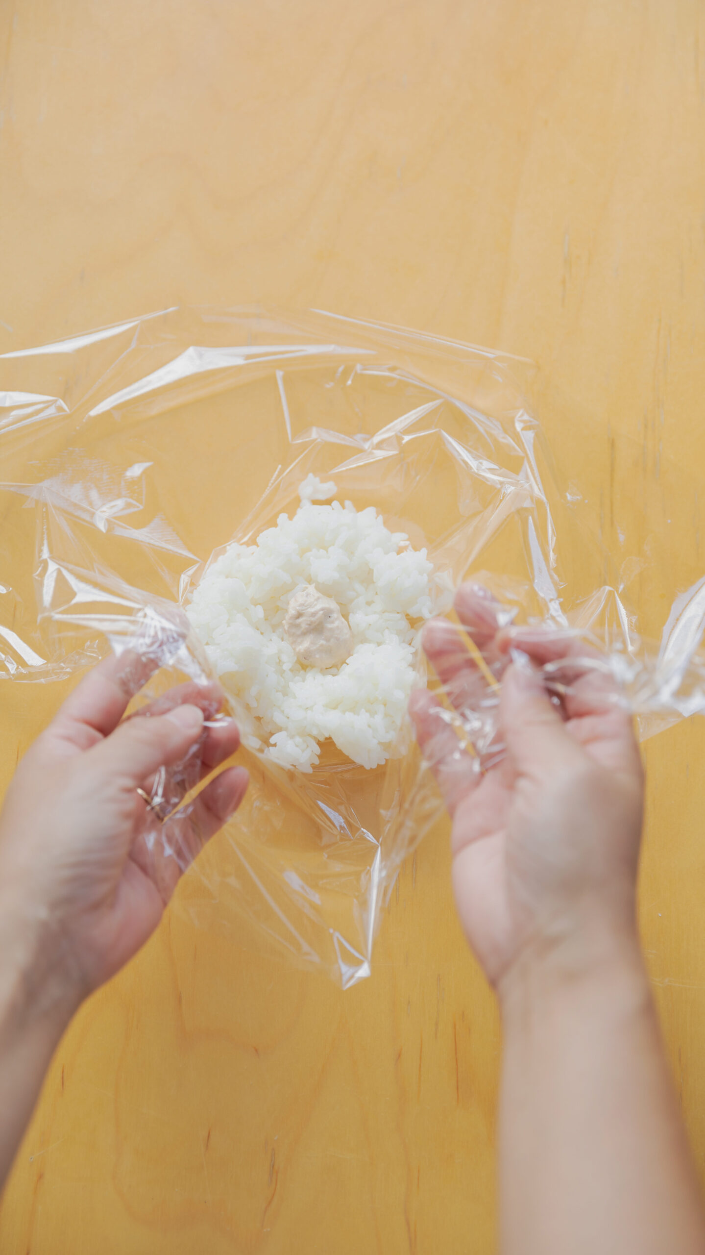 Four types of Japanese onigiri rice balls including salmon and tuna mayo on a bamboo basket