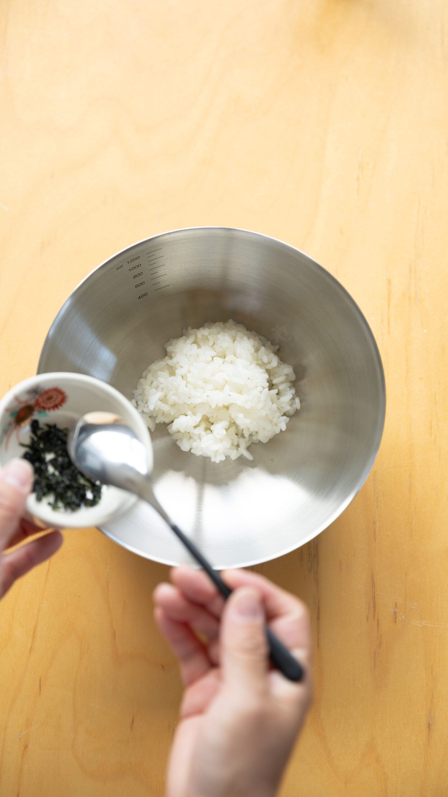 Four types of Japanese onigiri rice balls including salmon and tuna mayo on a bamboo basket