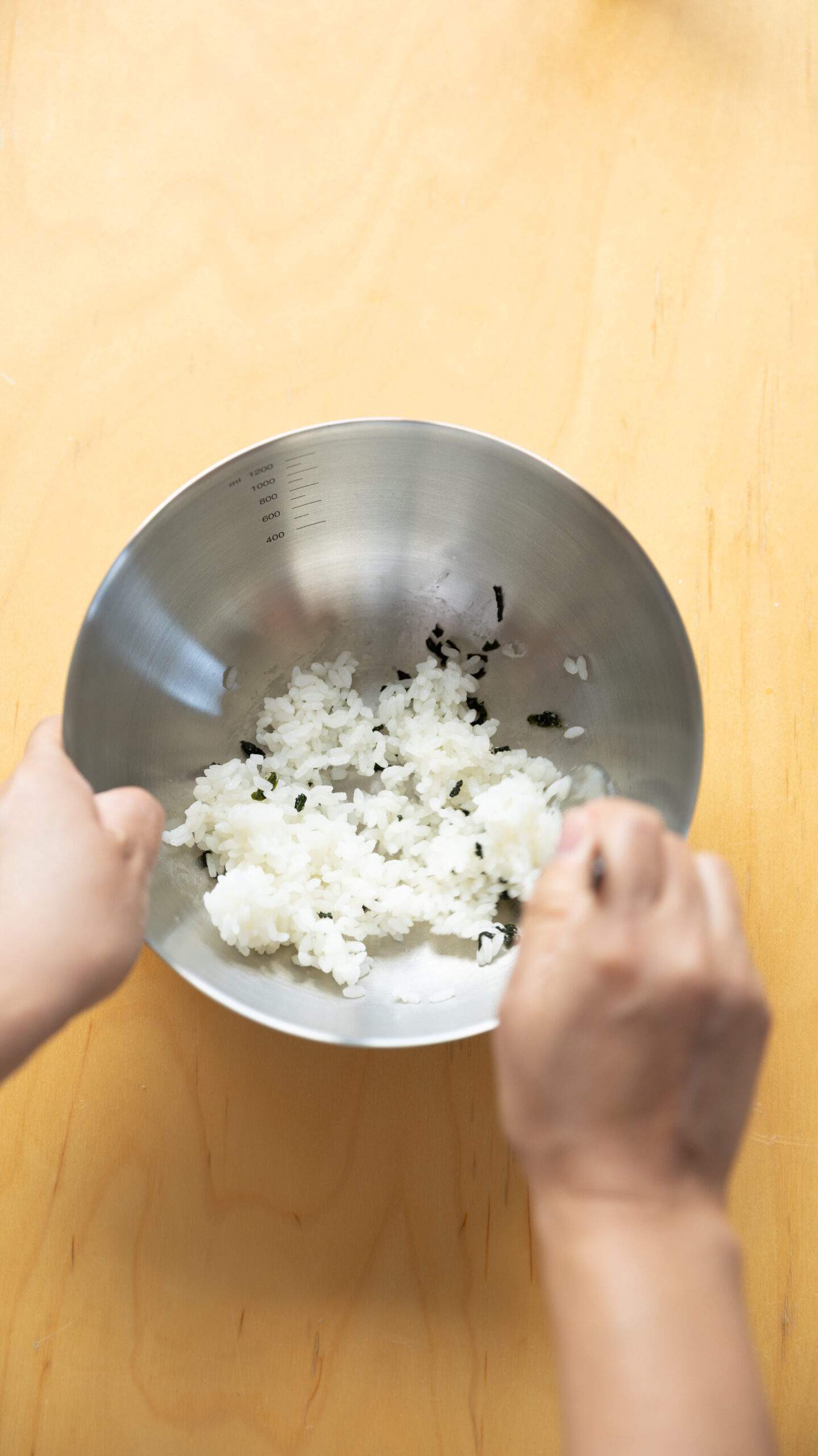 Four types of Japanese onigiri rice balls including salmon and tuna mayo on a bamboo basket