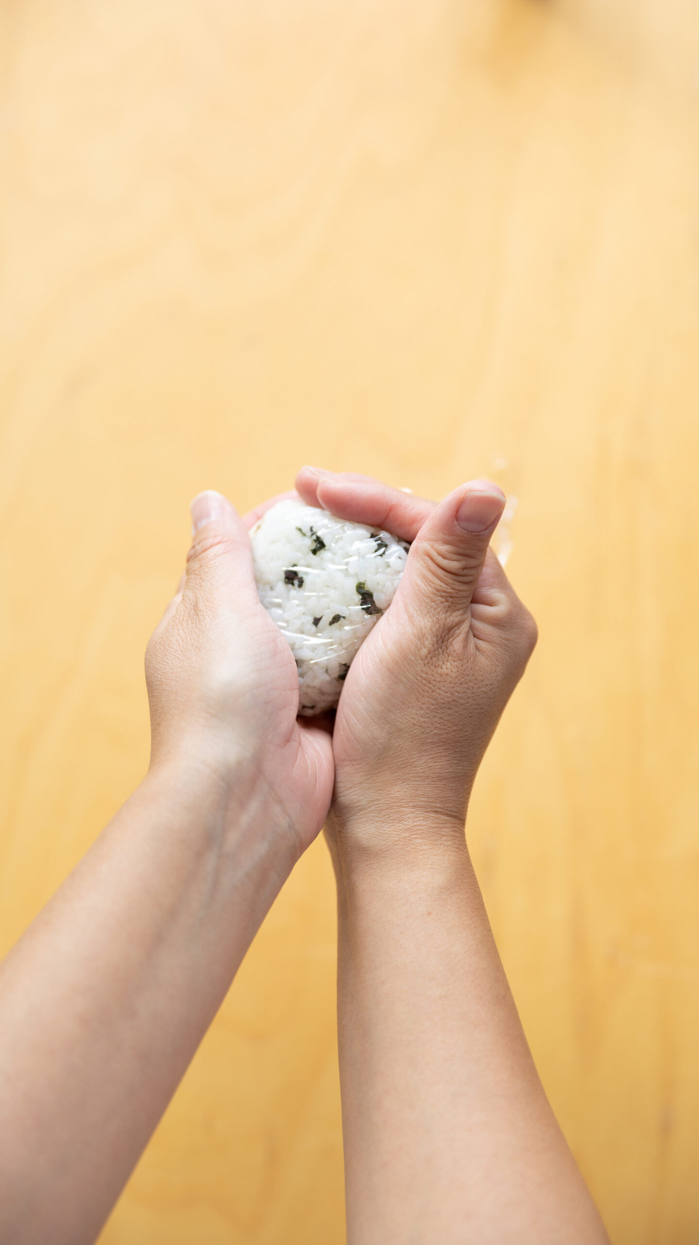 Four types of Japanese onigiri rice balls including salmon and tuna mayo on a bamboo basket