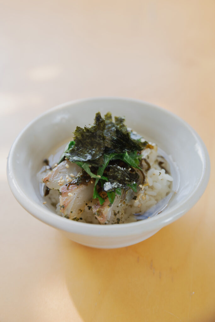 Homemade Japanese kobujime sliced fresh sea bream cured with shio-kombu on a plate