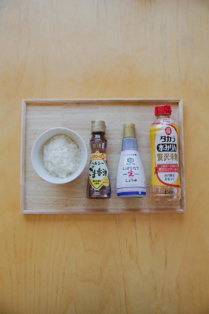 A bottle of Japanese soy sauce and mirin on a wooden table for making yaki-onigiri