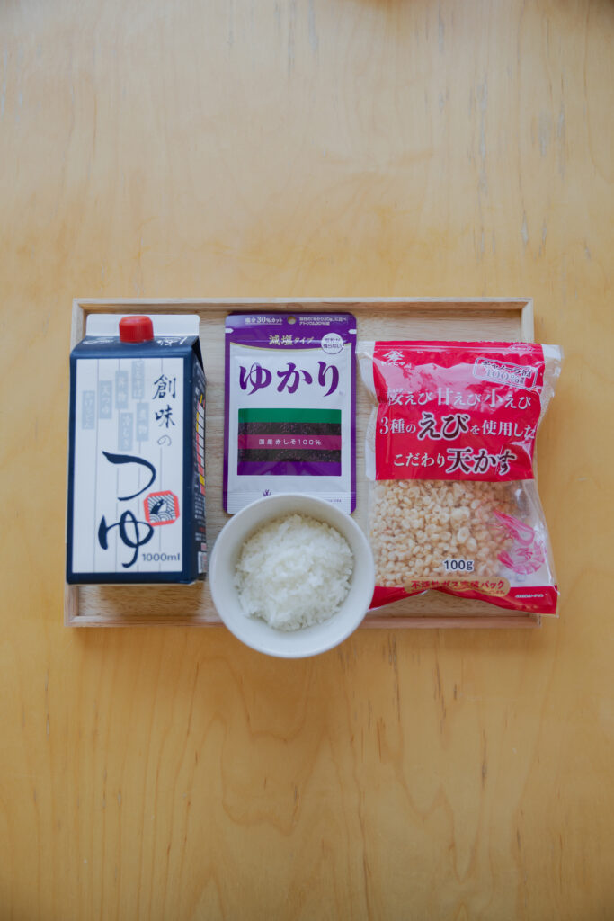 A packet of purple Yukari red shiso rice seasoning and crunchy tempura flakes