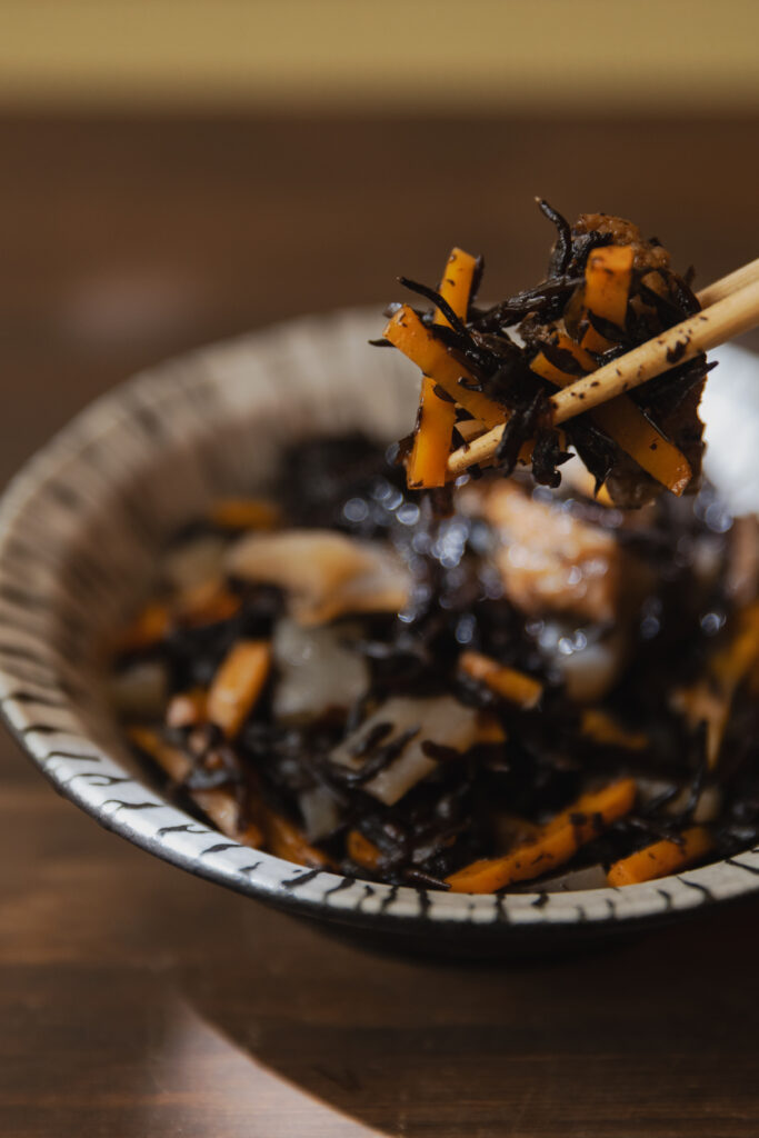 Healthy Japanese Hijiki seaweed salad picked up with chopsticks